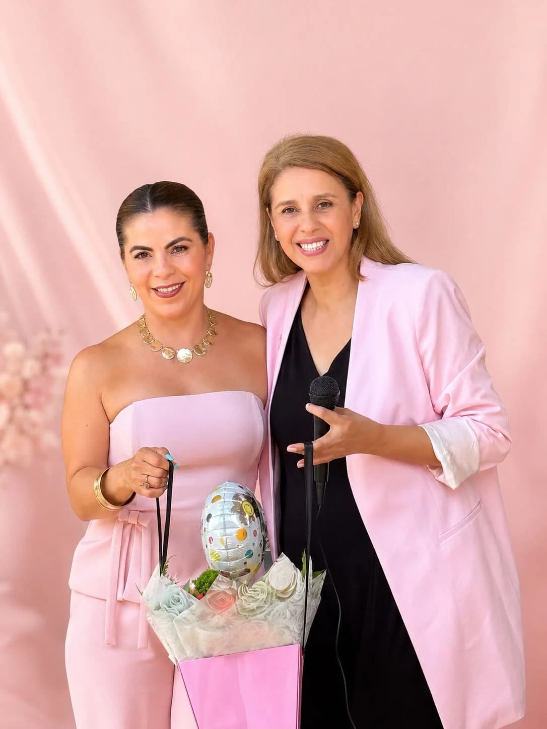 Two anniversary guests posing with a gift