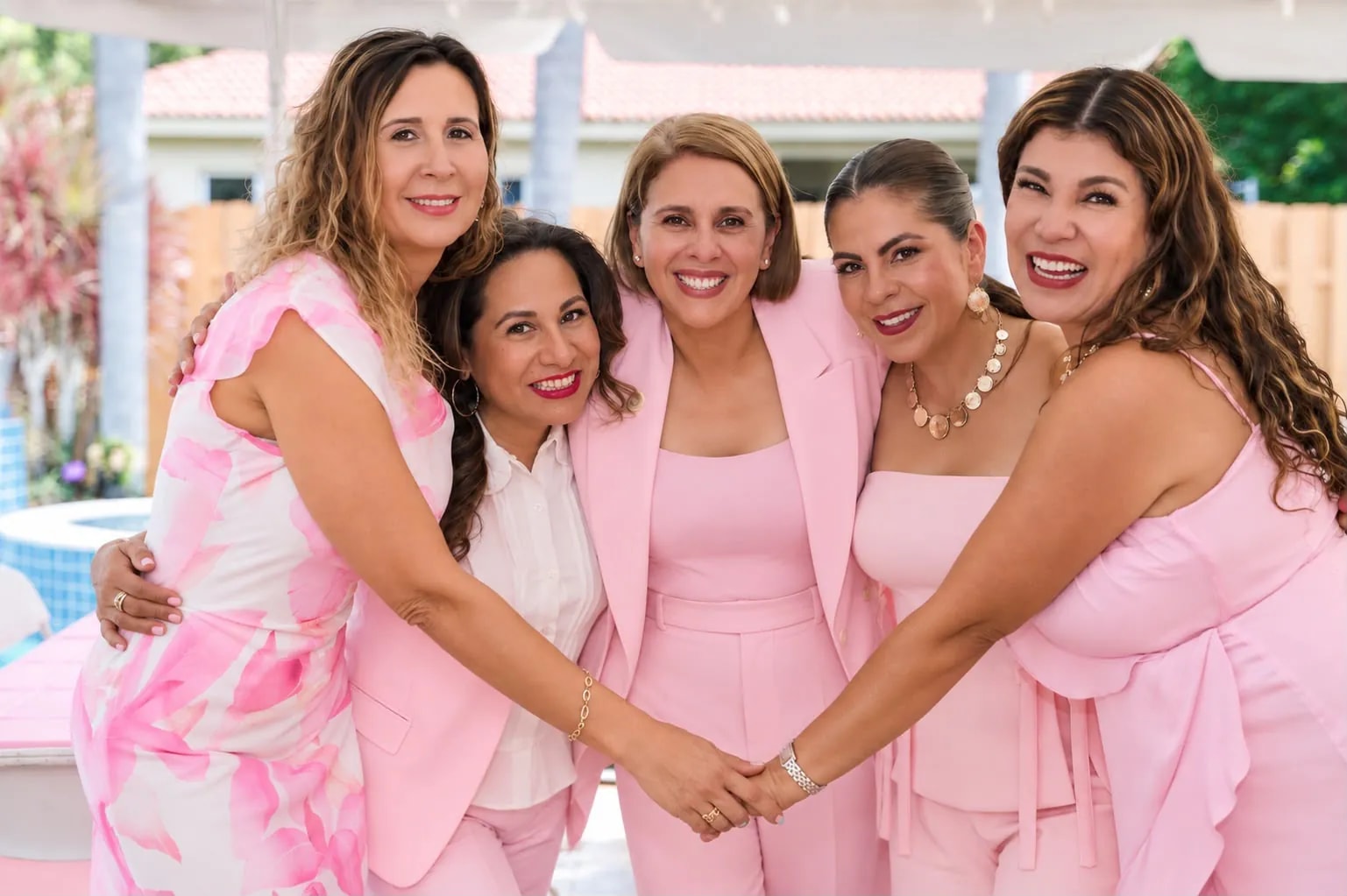 Five guests embrace, hands joined